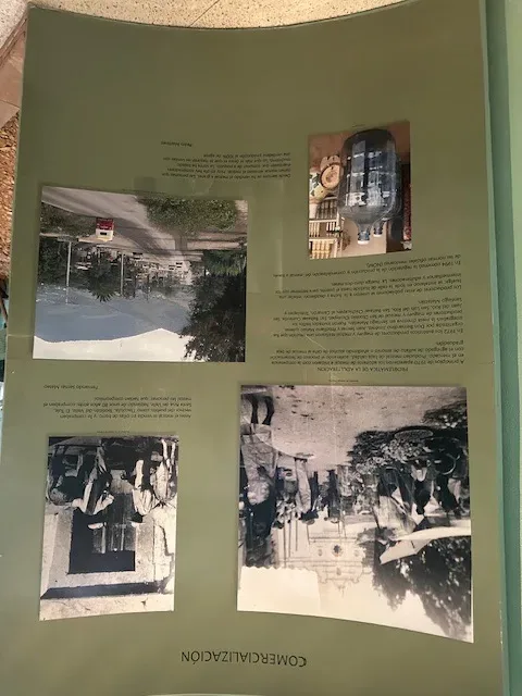 Museum exhibit panel "Comercialización" at the Mercado de Santiago Matatlán, with historical photographs of the mezcal market and the text recounting the 1972 strike led by Juan Sernas.